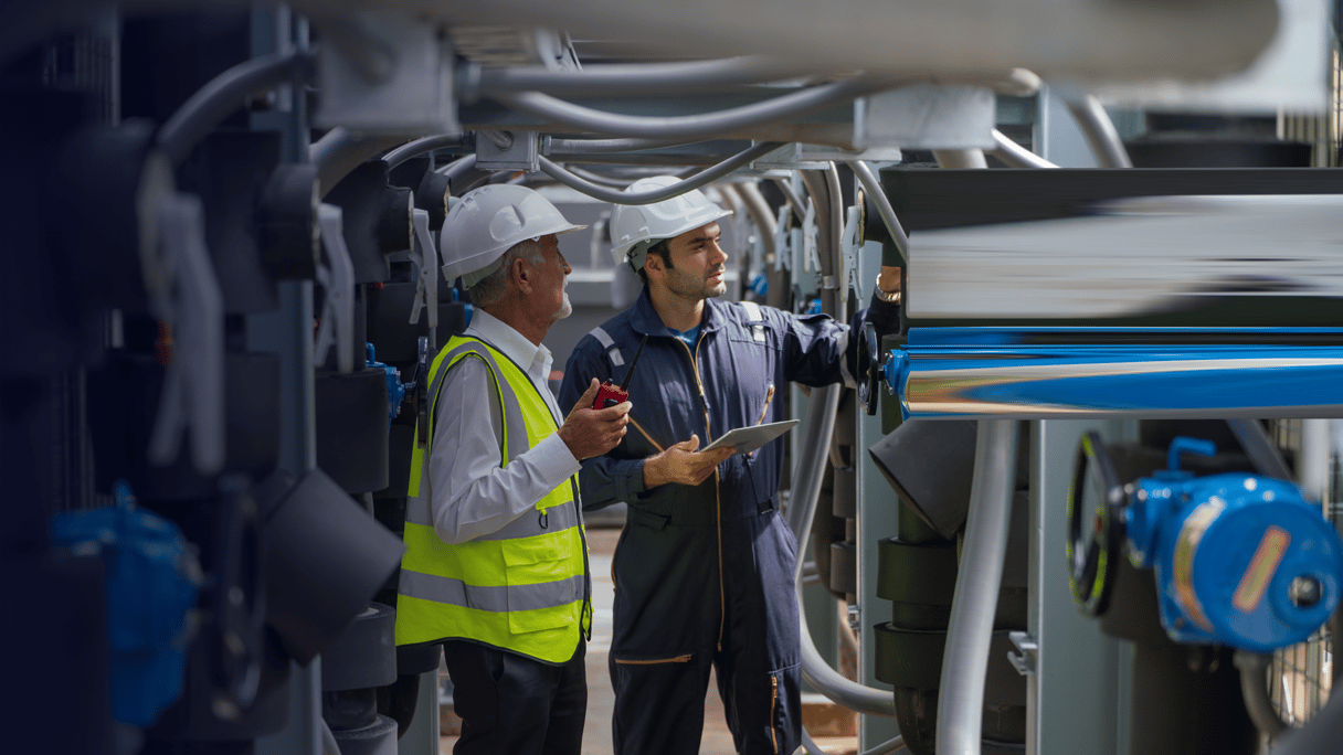 OGE_Two Caucasian engineer as young and senior worker discuss together and stay in channel of pipe By nrradmin_2_envato