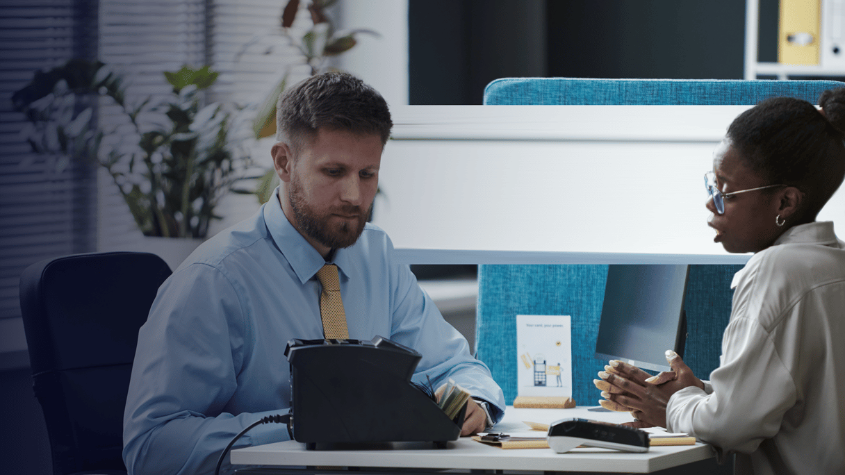 policy expert_Caucasian Man Consulting Black Young Woman in Bank Office By DragonImages_envato