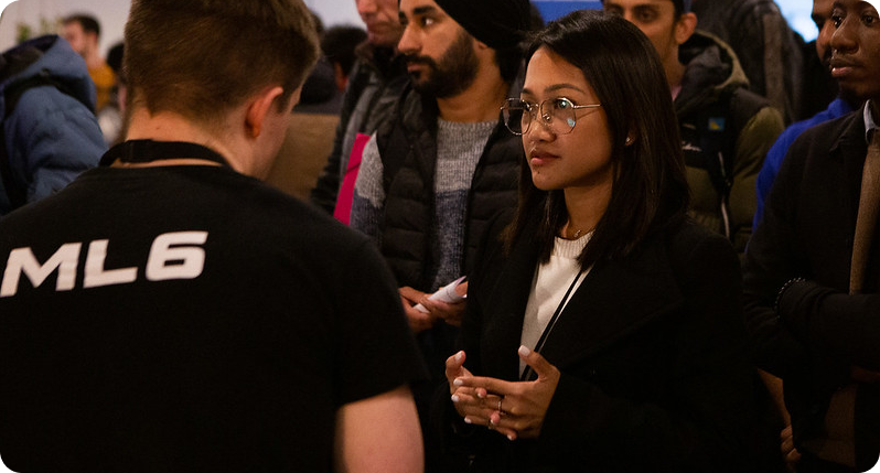 Man with ML6 t-shirt and other people