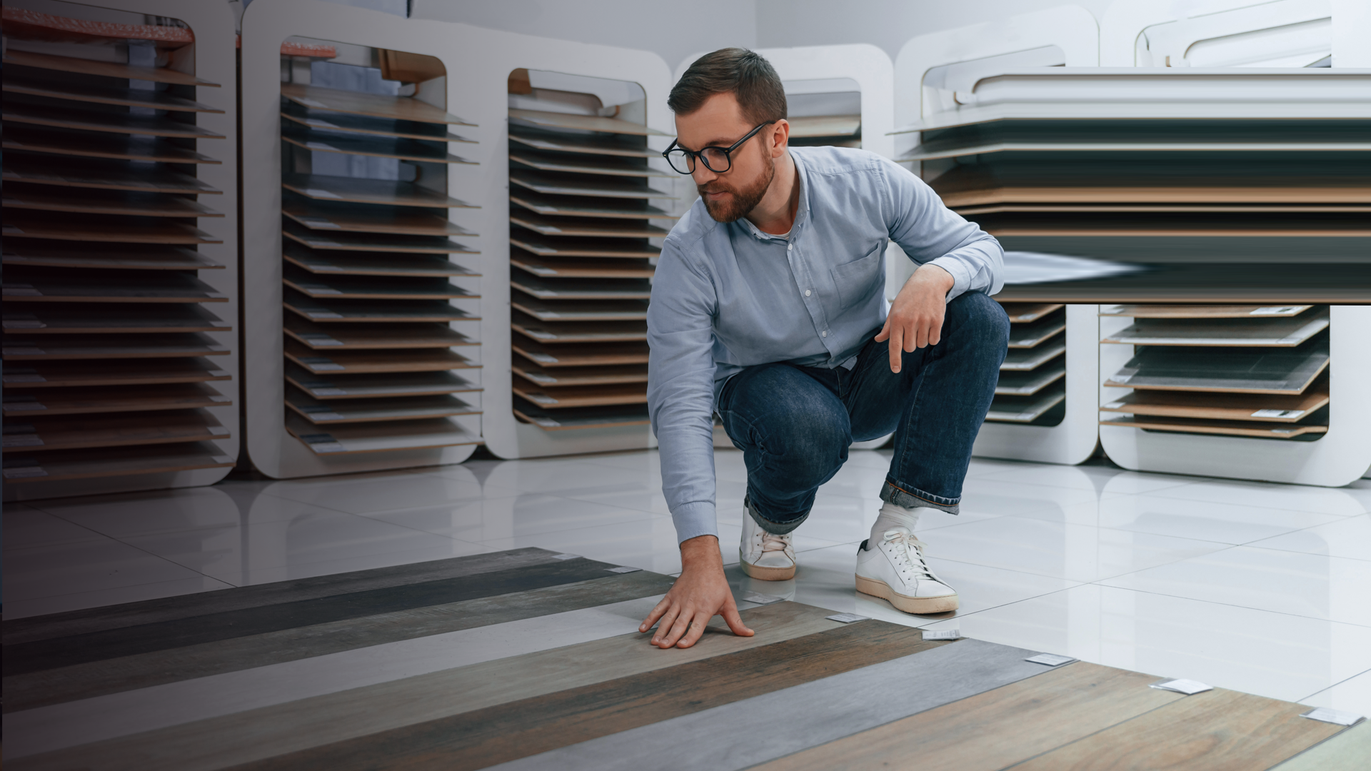 S_Kronos_Sitting and choosing parquet. Man is in the store of goods for the home By mstandret_envato