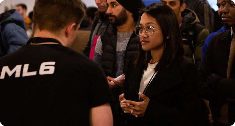Man with ML6 t-shirt and other people