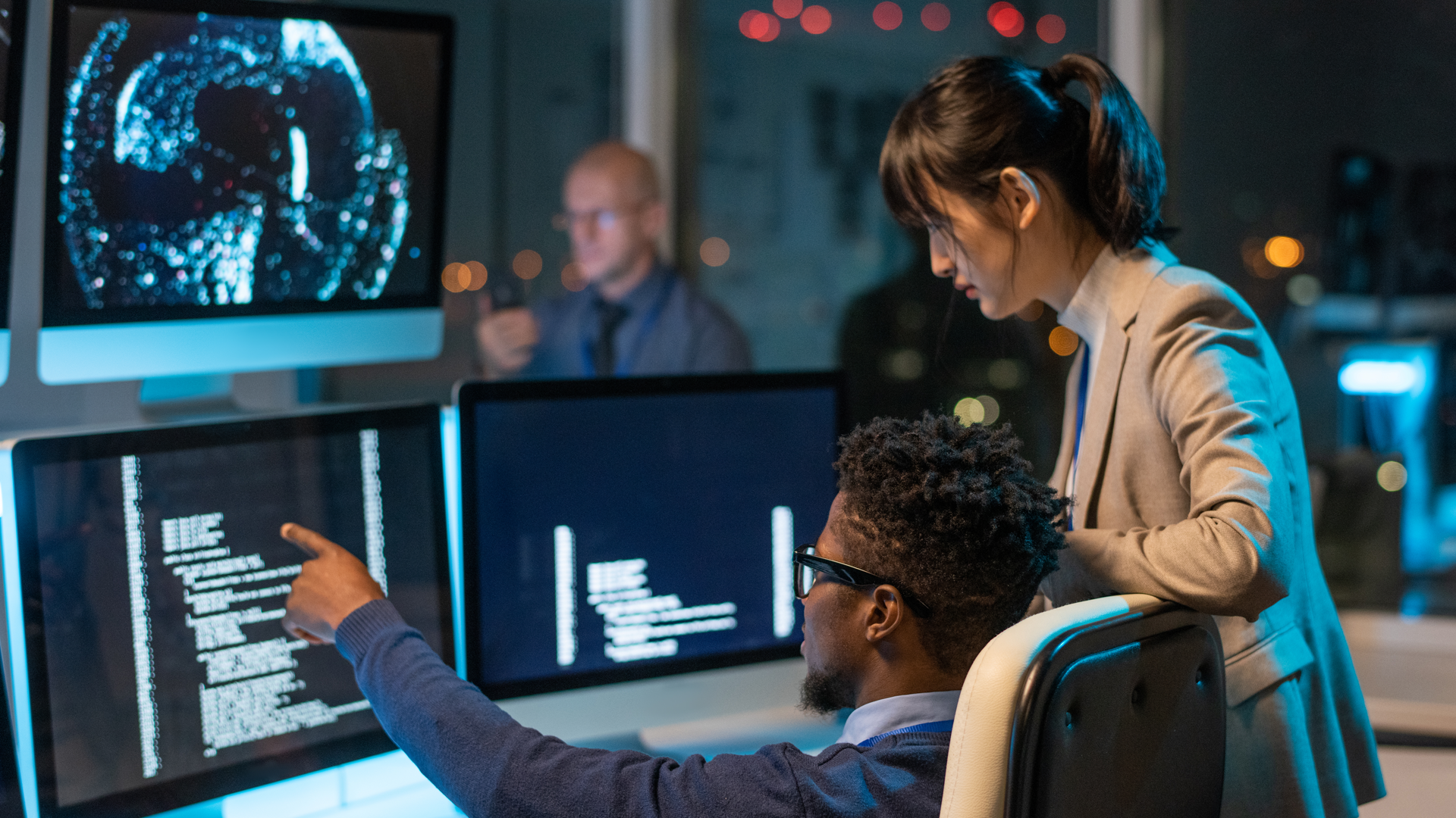 man and woman looking at screen